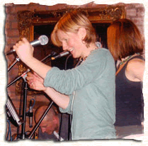 kate doubleday and two of her band members at a gig